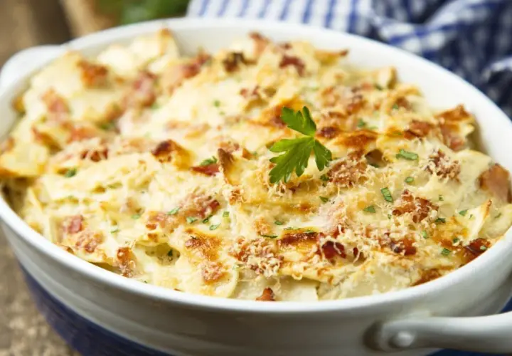 Gratin dauphinois crémeux avec lardons, garni de persil. Un plat réconfortant, idéal pour savoir quel vin avec quel plat.