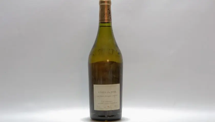 Bouteille de vin blanc des Côtes du Jura, millésime non visible, sur fond blanc.