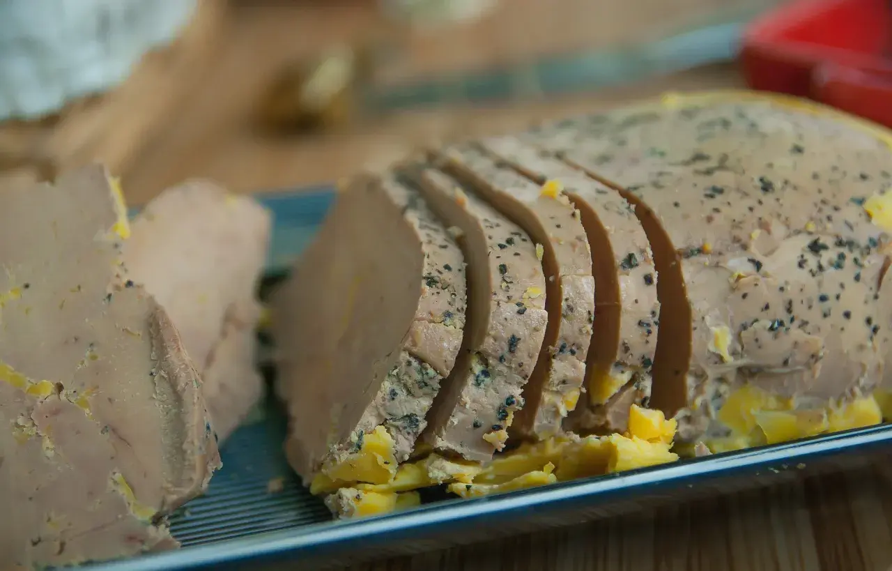 Tranches de foie gras assaisonnées de poivre noir, prêtes pour un accord mets vins parfait.